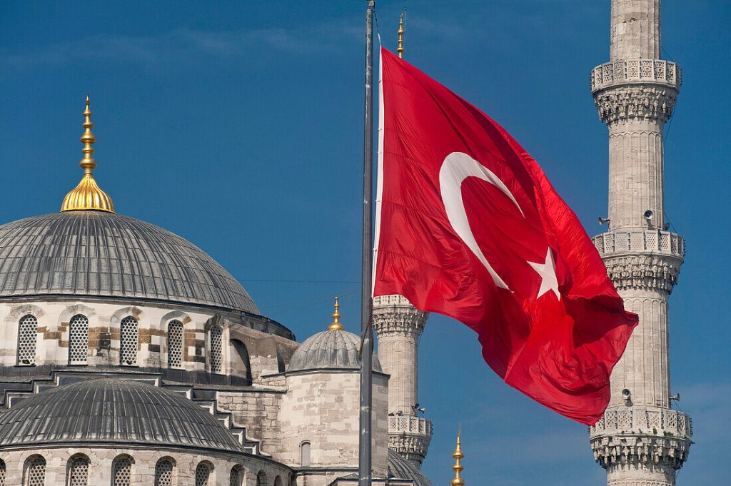 70373922 Turkish flag in front of the Sultanahmet or Blue Mosque Istanbul Turkey