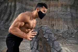 side view of man in black mask using heavy tyre fo 3bnwl4x 1024x683