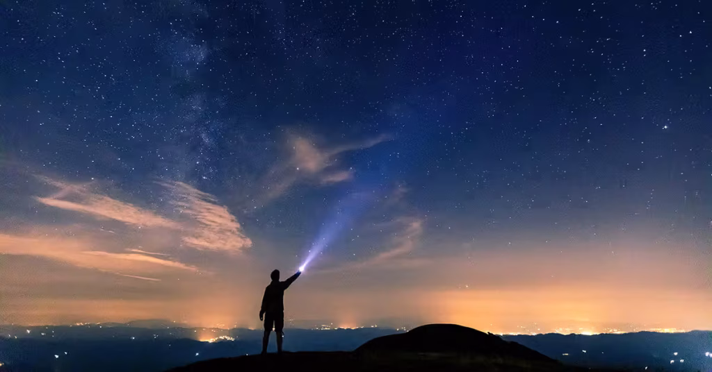 man standing night sky stars light outdoors 1200x628 facebook 1200x628 1