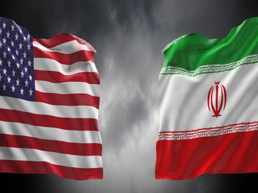 u s and iranian flags wave against a dark cloudy sky