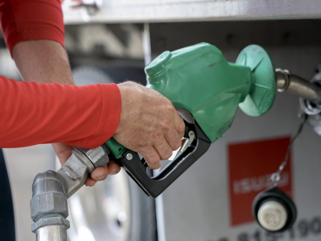 d3755a 20260305 close up of a man pumping diesel fuel into a truck 1400